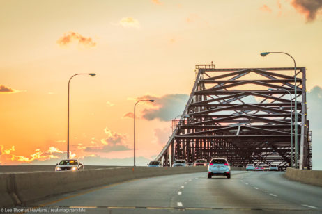 Cars make their way across the High Bridge on the Chicago Skyway at sunset.