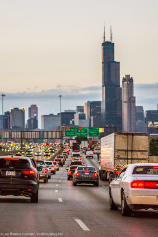 The Sears Tower stands prominently in Downtown Chicago as cars slow down for a traffic jam on the Dan Ryan Expressway.