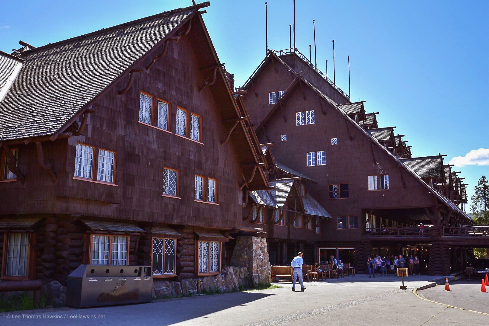 A rustic brown wooden building rises five stories.